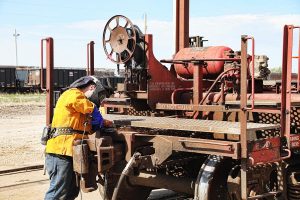 A Cathcart Rail employee working on a railcar