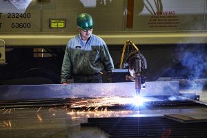 A Cathcart Rail employee welds metal