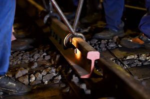 Cathcart Rail team members fixing track with new rail